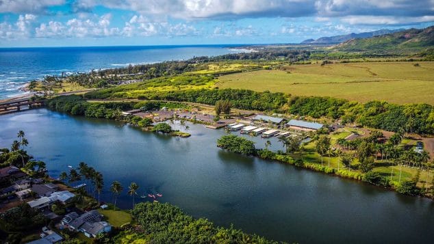 Drone view of Wailua River meeting the Pacific Ocean on Kauai’s east side, near the launch point for Kayak Adventures Kauai tours.