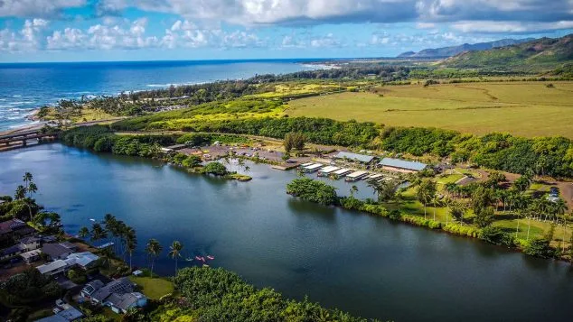 Drone view of Wailua River meeting the Pacific Ocean on Kauai’s east side, near the launch point for Kayak Adventures Kauai tours.