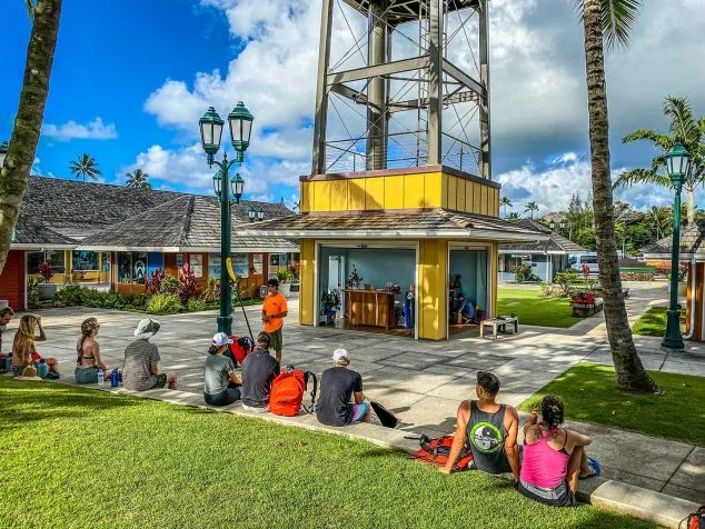 Kayak Adventures Kauai group receiving pre-tour instructions at the Coconut Marketplace check-in site.
