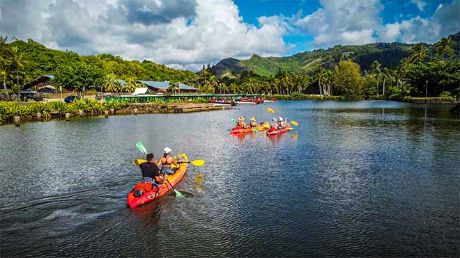 A group of kayakers on a tour of the Wailua river, Kauai with Kayak Adventures Kauai.